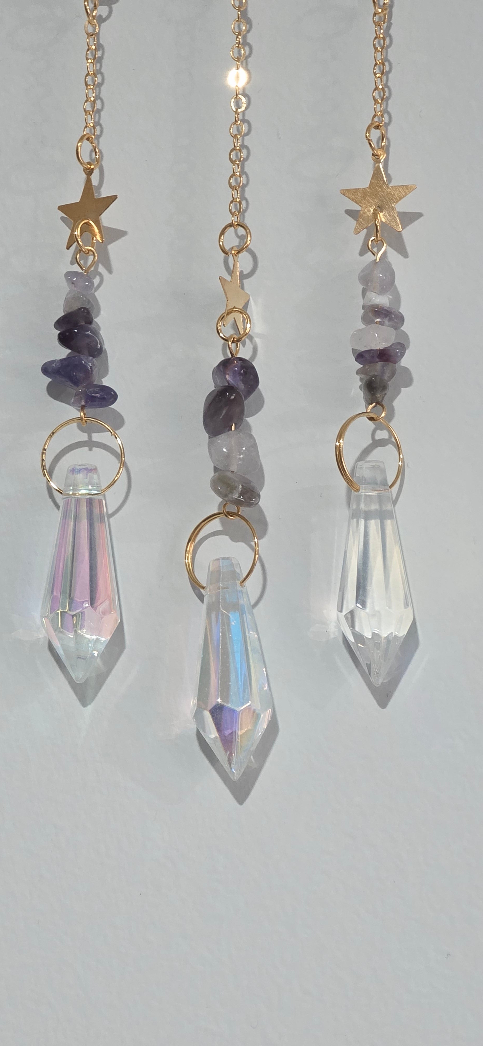 Glass crystal accents, amethyst crystal cips and gold stars at the bottom of a suncatcher